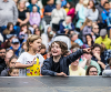 A crowd shot from SIRF 2023 showing two children at the front enjoying the performance with one pointing excitedly at something.