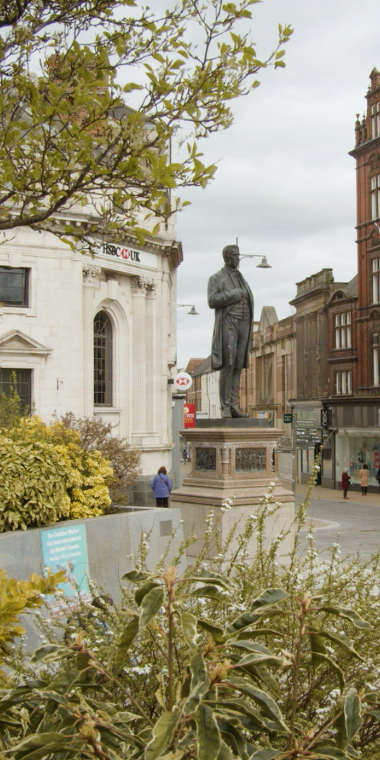 Joseph Pease statue in Darlington and the surrounding shops.