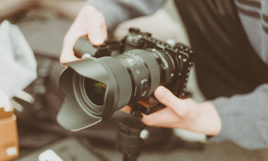 person holding a digital camera 